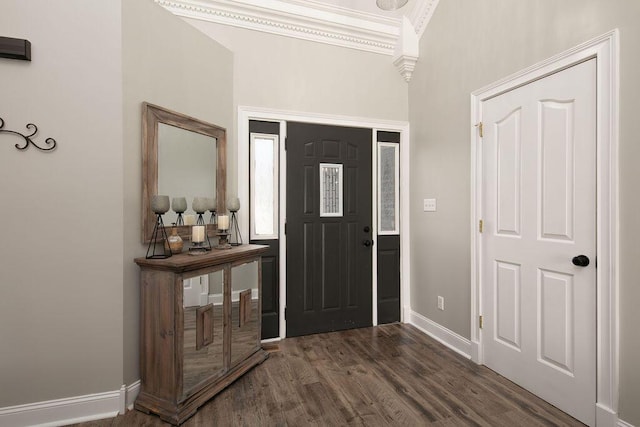 foyer entrance with baseboards, dark wood-style floors, and ornamental molding