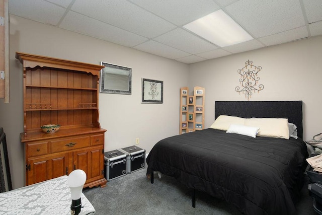 carpeted bedroom with a drop ceiling