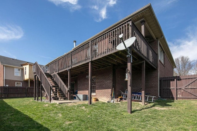 back of house featuring stairs, brick siding, and a wooden deck