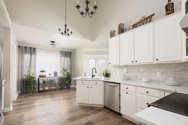 kitchen with an inviting chandelier, a sink, dark wood-type flooring, white cabinets, and stainless steel dishwasher