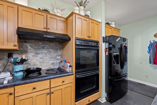 kitchen with black appliances, dark countertops, tasteful backsplash, and under cabinet range hood