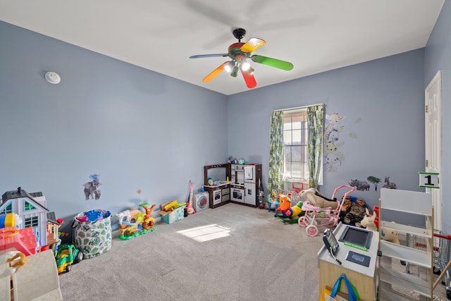 recreation room with carpet flooring and a ceiling fan