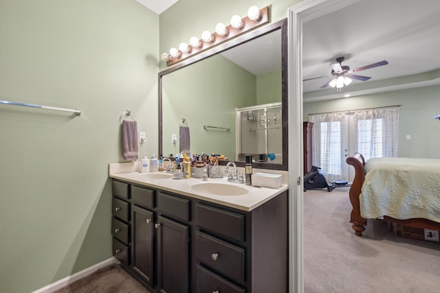 ensuite bathroom with a sink, a shower with shower door, ensuite bath, and double vanity