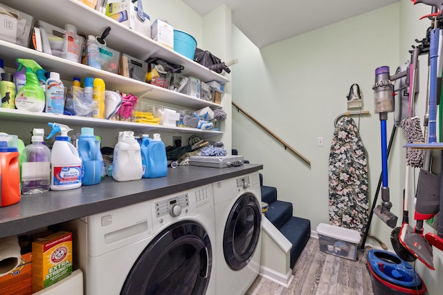 laundry room featuring baseboards, independent washer and dryer, wood finished floors, and laundry area