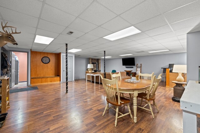 dining room featuring wood finished floors, visible vents, and a paneled ceiling