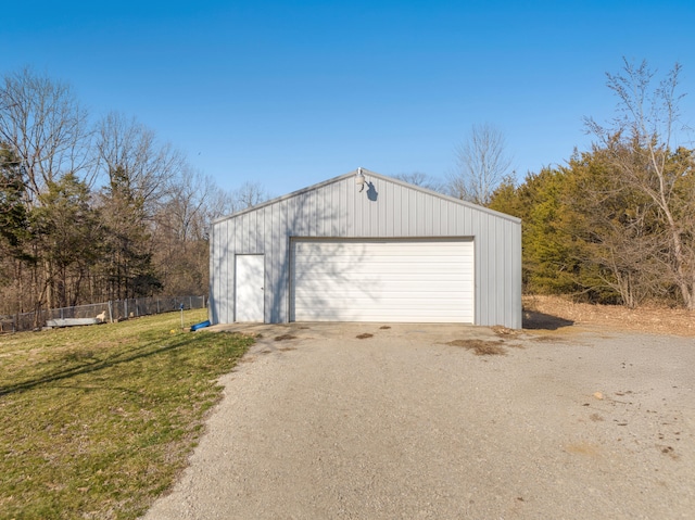 detached garage featuring fence