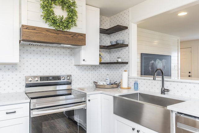 kitchen featuring open shelves, a sink, stainless steel appliances, light countertops, and white cabinets