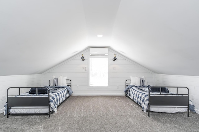 bedroom with lofted ceiling, a wall mounted AC, carpet floors, wood walls, and baseboards