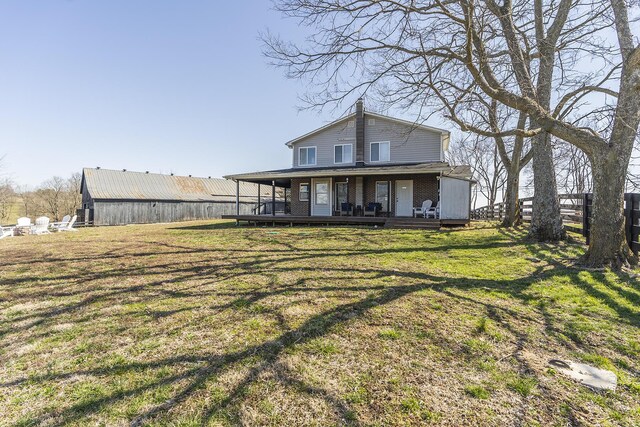 deck with a rural view and a yard