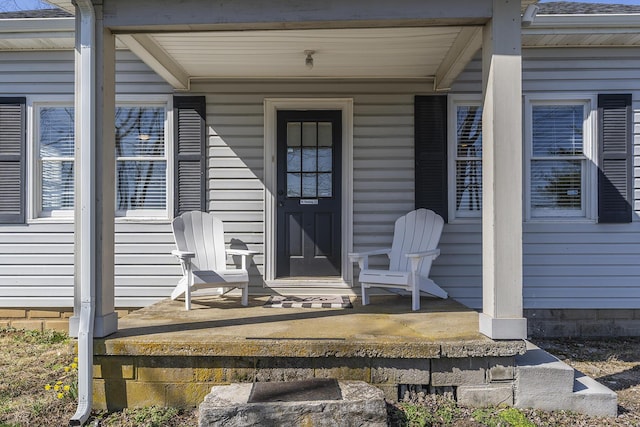 view of exterior entry featuring covered porch