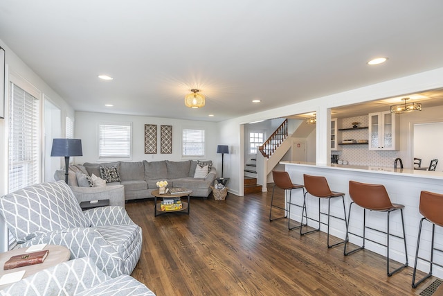 living area featuring recessed lighting, stairway, and dark wood finished floors