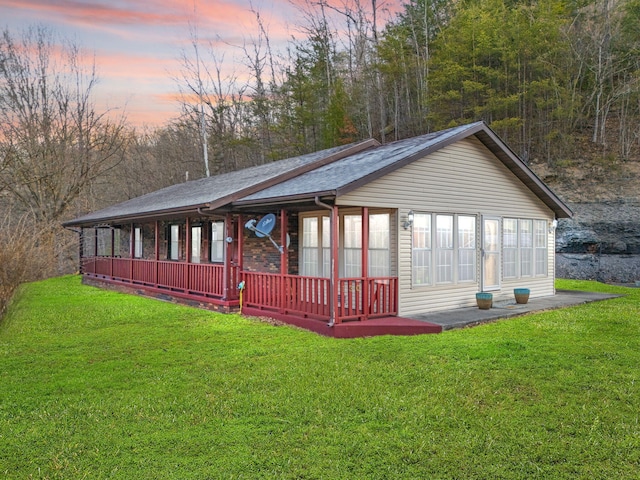 exterior space with a lawn and a porch