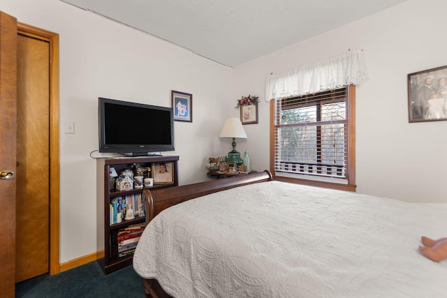 carpeted bedroom featuring baseboards