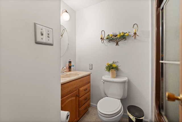 bathroom featuring vanity, toilet, and baseboards