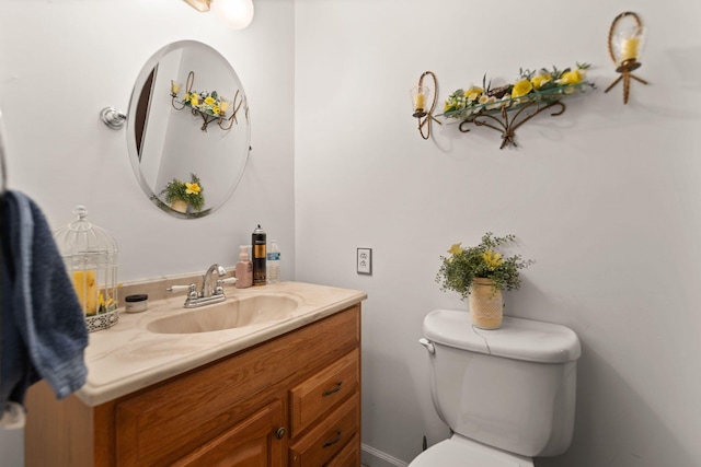 bathroom featuring toilet and vanity