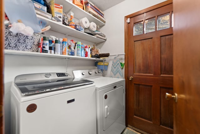 clothes washing area featuring washing machine and clothes dryer and laundry area