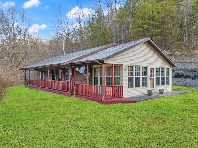 exterior space featuring covered porch and a front lawn