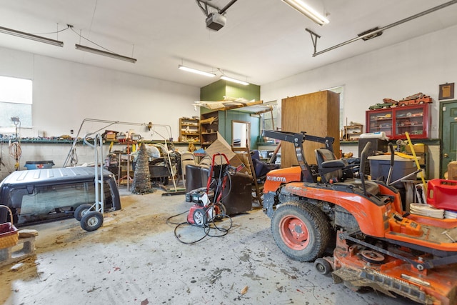 garage with a workshop area and a garage door opener