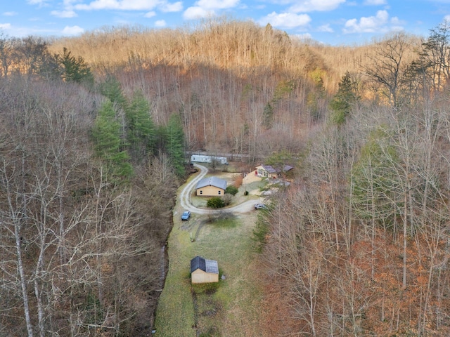 birds eye view of property featuring a view of trees