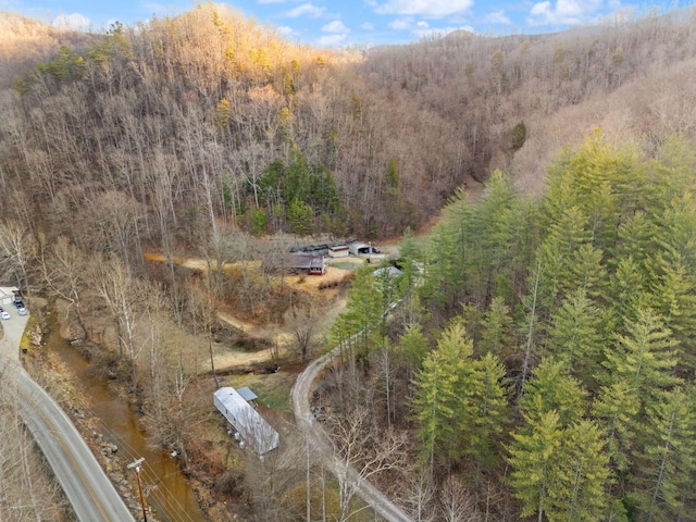 birds eye view of property featuring a view of trees