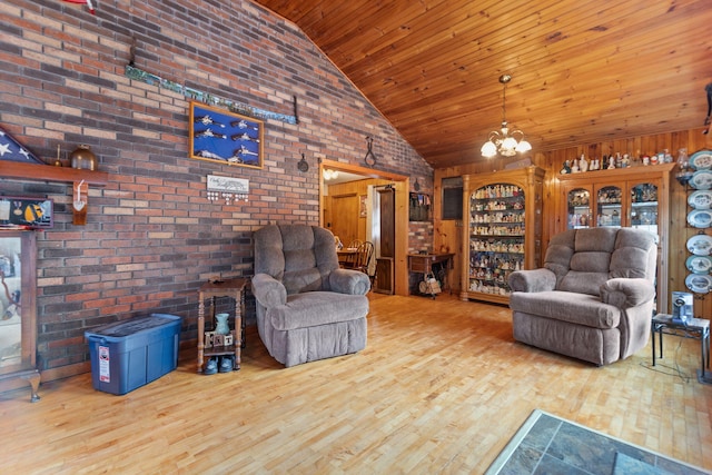 unfurnished living room featuring wood finished floors, brick wall, high vaulted ceiling, an inviting chandelier, and wooden ceiling