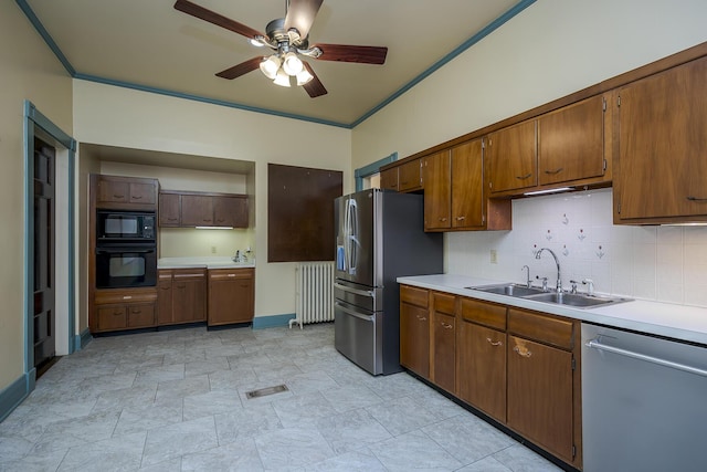 kitchen with visible vents, ceiling fan, radiator heating unit, black appliances, and a sink