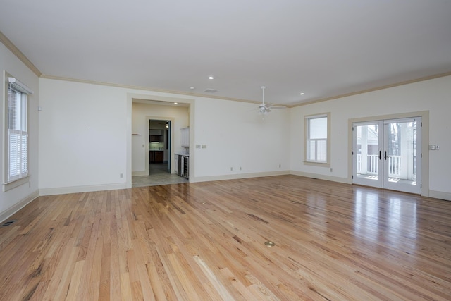 unfurnished room featuring french doors, baseboards, light wood-style flooring, and ornamental molding