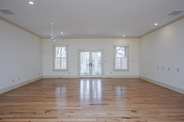 unfurnished living room with visible vents, french doors, light wood-type flooring, and crown molding