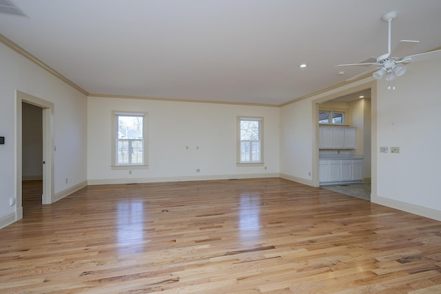 empty room with baseboards, light wood-style floors, visible vents, and ceiling fan