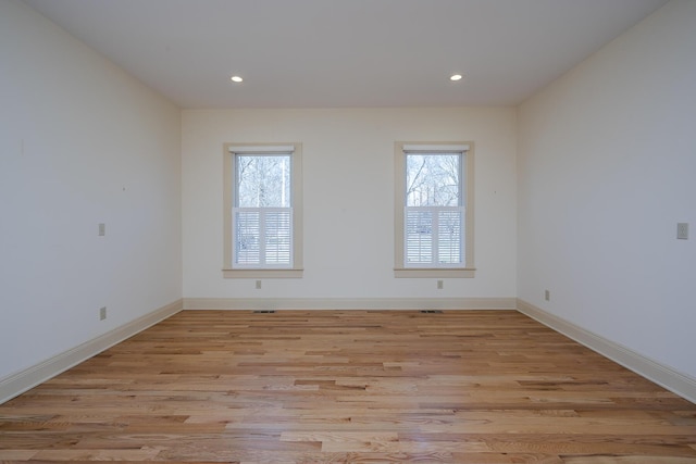 unfurnished room featuring recessed lighting, baseboards, and light wood-style floors