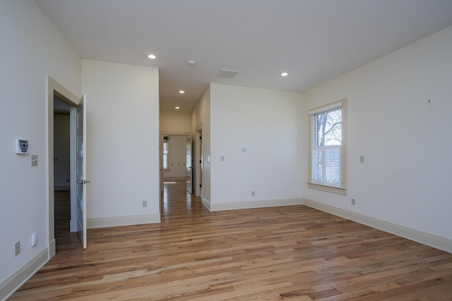 empty room with recessed lighting, visible vents, baseboards, and light wood finished floors