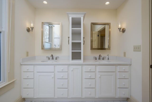 bathroom with a sink, recessed lighting, and double vanity