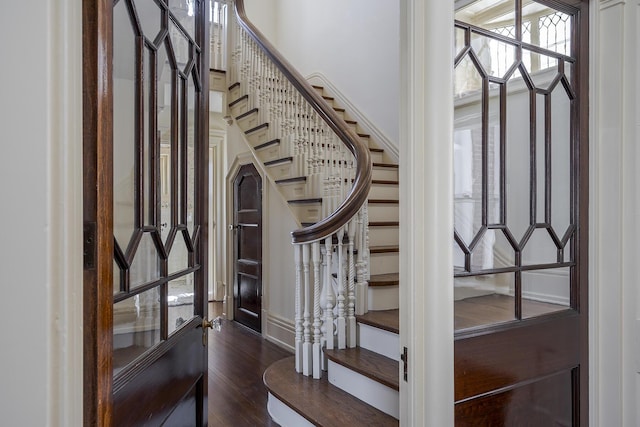 foyer entrance featuring stairway and wood finished floors