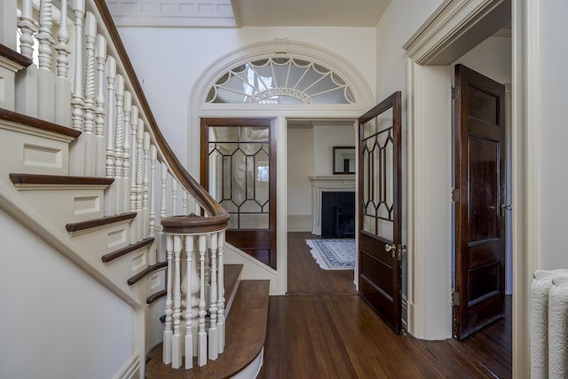 entrance foyer with dark wood finished floors and stairs