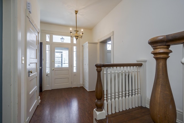 foyer featuring a chandelier and wood finished floors