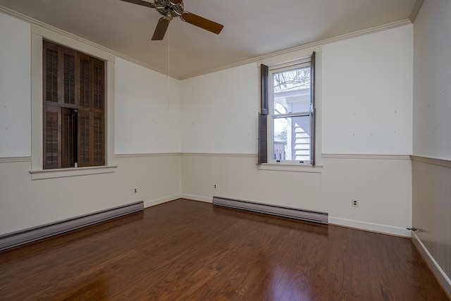 unfurnished room featuring crown molding, wood finished floors, baseboard heating, and ceiling fan