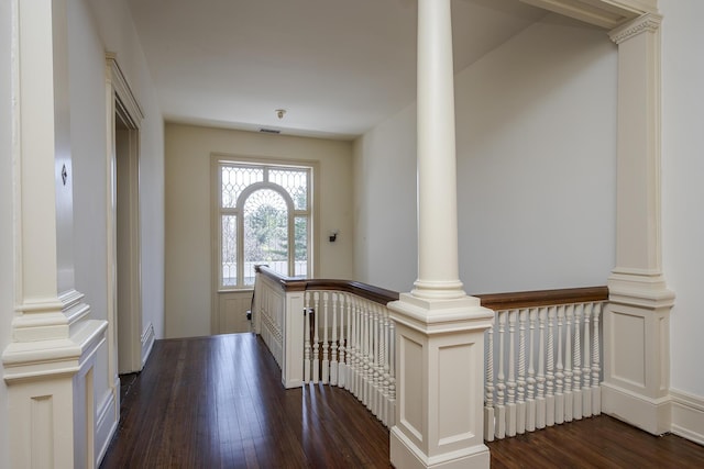 foyer featuring decorative columns, visible vents, and dark wood-style flooring