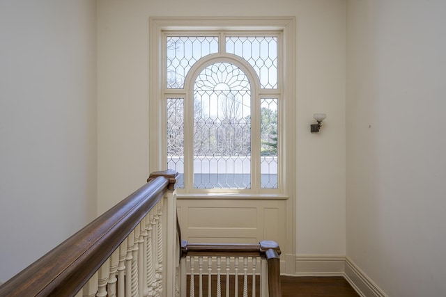 interior space with baseboards and dark wood-style flooring