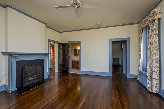 unfurnished living room featuring visible vents, wood finished floors, and ornamental molding