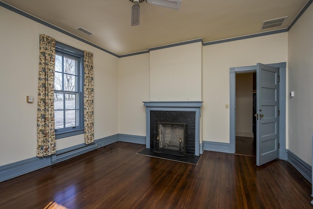 unfurnished living room featuring ceiling fan, visible vents, a fireplace with flush hearth, and wood finished floors