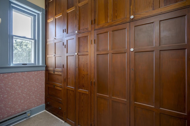 interior details with baseboards and wallpapered walls