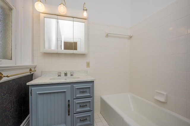 full bathroom featuring tile patterned floors, tile walls, and vanity