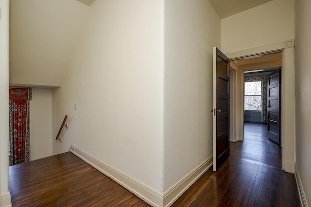 hall featuring dark wood finished floors and baseboards