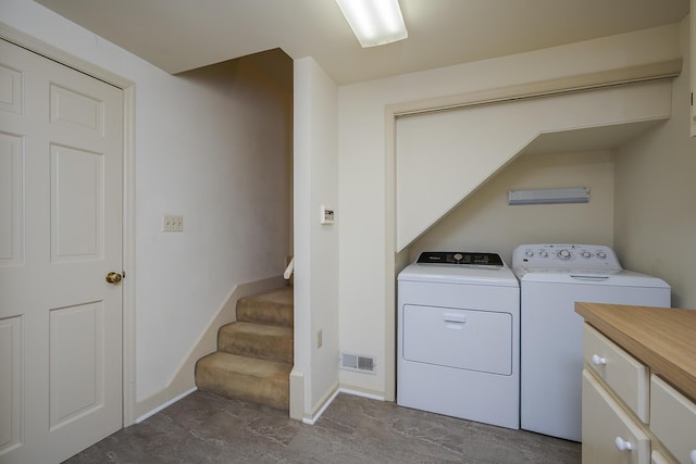 laundry area featuring washer and dryer, laundry area, baseboards, and visible vents