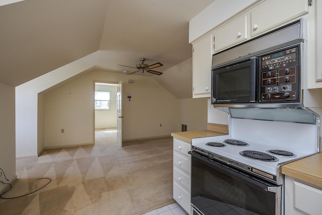 kitchen with ceiling fan, black microwave, lofted ceiling, light carpet, and white cabinets