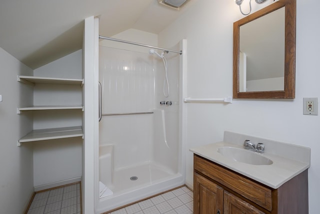 full bath with visible vents, tile patterned flooring, a shower, lofted ceiling, and vanity