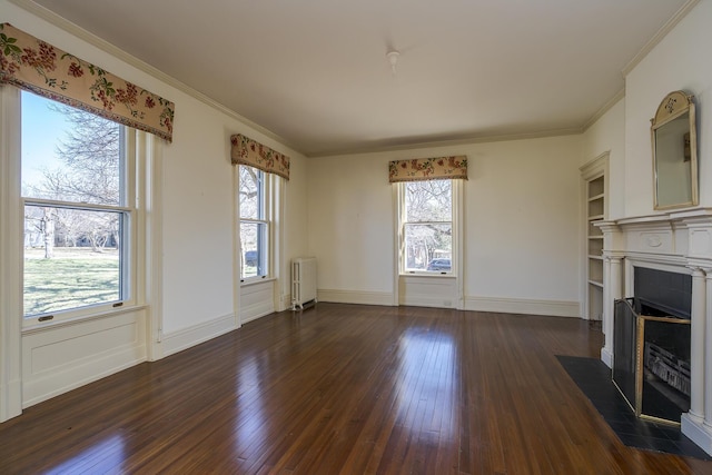 unfurnished living room with baseboards, dark wood finished floors, radiator heating unit, a fireplace with flush hearth, and ornamental molding