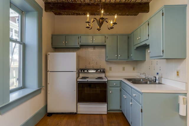 kitchen with white appliances, dark wood finished floors, a sink, beamed ceiling, and a chandelier