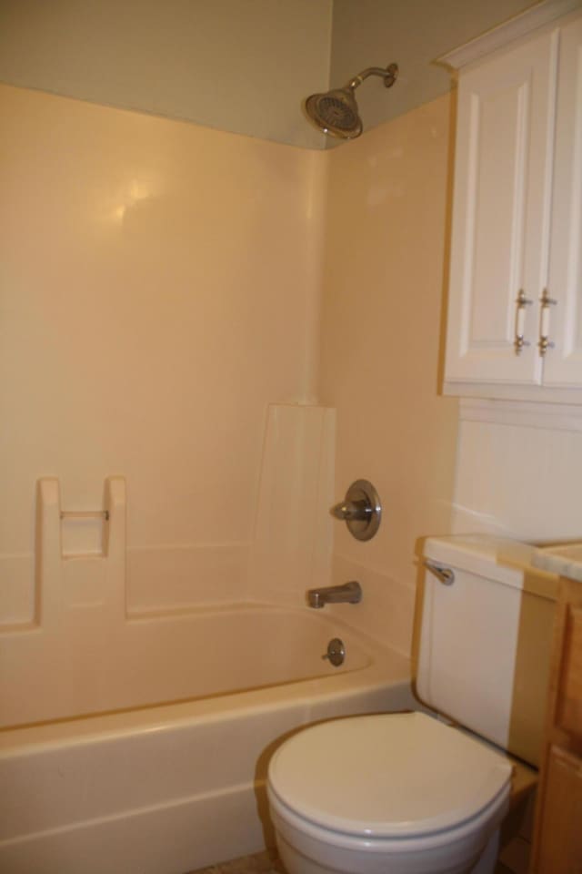 bathroom featuring toilet, shower / washtub combination, and vanity