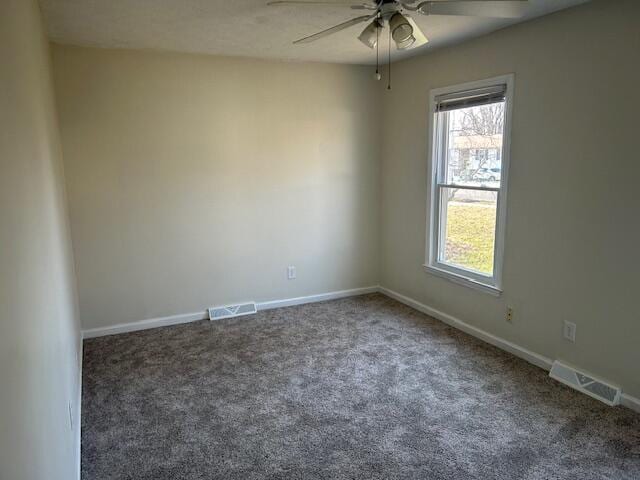 unfurnished room featuring visible vents, carpet floors, baseboards, and a ceiling fan